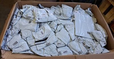 a cardboard box full of white shirts and pants