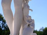 a statue of a woman holding a fish in her hand