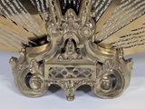 a gold fan that is sitting on a white table