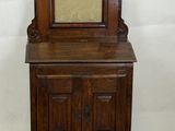 un petit meuble en bois surmonté d'une horloge