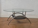 a glass table with a magazine rack underneath it