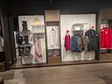 a photo of a clothing store with clothes on display