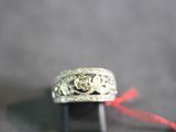 a silver ring with a red string around it