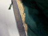 a close up of a green purse with a gold trim