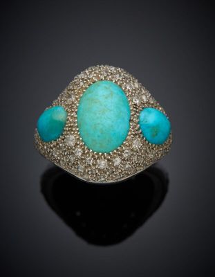 an image of a turquoise stone and diamond ring on a black surface