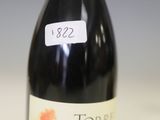 une bouteille de vin posée sur une table à côté d'une bouteille de vin