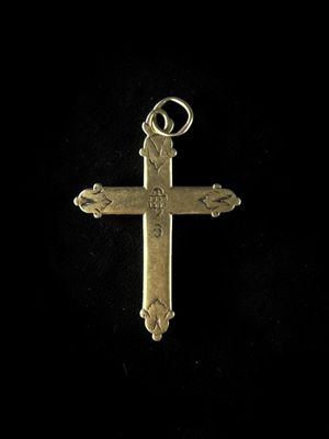 a gold cross pendant with a cross on it ' s side
