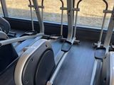 a row of stationary exercise bikes in the gym