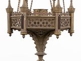 a large ornate hanging light fixture with a chain