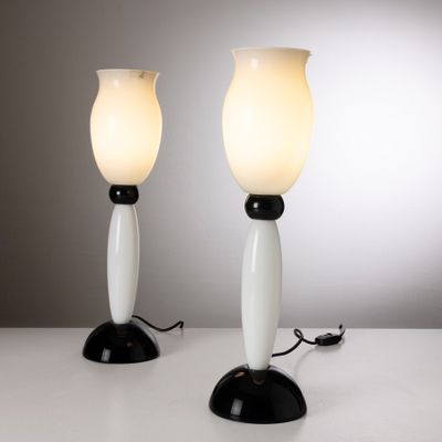pair of white and black table lamps on a white surface