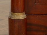 a small wooden object on the floor next to a door