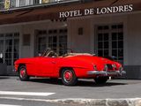 a red car parked in front of a hotel