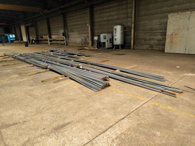a large pile of steel rods in a warehouse