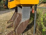 a yellow machine that is sitting on the side of the road