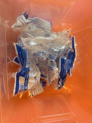 a plastic container filled with plastic items on a table