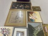 a lot of framed pictures on a table in a room