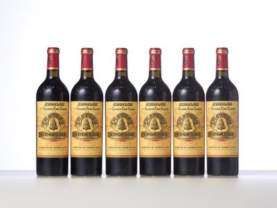 four bottles of wine are lined up on a table