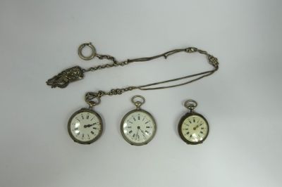 three different types of pocket watches on a white surface