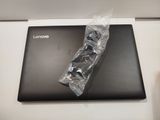 a black laptop with a plastic wrap on top of it