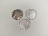 three different types of coins are shown on a white surface