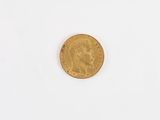 a close up of a gold coin on a white surface
