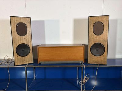 three speakers that are sitting on top of a blue table