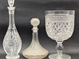 three glass items are sitting next to each other on a table