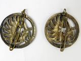 pair of antique brass brooches depicting a woman and a bird