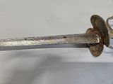 a very old sword that is on a white table