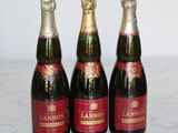 three bottles of wine sitting on top of a marble counter top