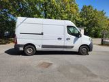 a white van parked in a parking lot next to trees