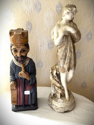 a statue of a man and a woman sitting on a table