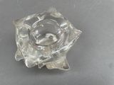 a clear glass candle holder on a table
