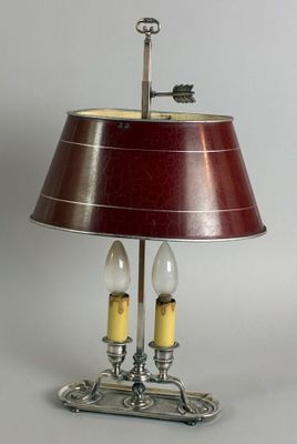 a lamp that is on a table with a red shade
