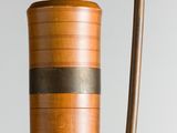 a wooden vase with a metal handle on a table