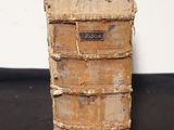 three old books stacked on top of each other on a black surface