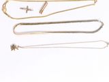 several different types of necklaces on a white surface