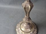 a silver candle that is sitting on a table