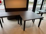 two tables and a bench in the corner of a restaurant