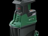 a close up of a green and black cleaning machine on a black background