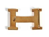 a gold letter h on a white background