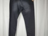 a pair of black jeans hanging on a white curtain