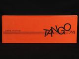an orange box with black writing on it sitting on a black surface