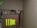 a cardboard box with a yellow sticker on it in a room