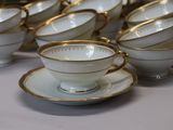 a lot of cups and saucers on the table