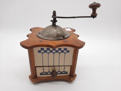 a coffee grinder sitting on top of a wooden table