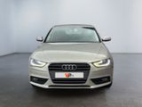 the front of a silver audi parked in a white room