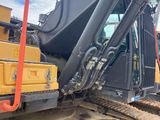 the back end of a yellow and black bulldozer sitting on top of a pile of dirt