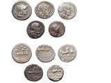 a close up of a bunch of coins on a white surface