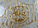 a close up of a plate with a gold design on it